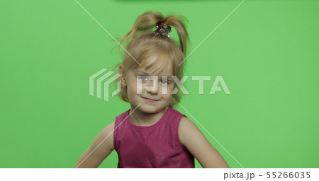 Positive girl looking to a camera in purple dress. Happy child. Chroma Key 55266035