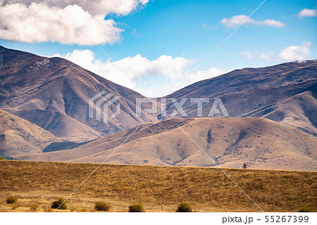 Young man cycling mountain bike along the rural Young man cycling mountain bike along the rural 55267399