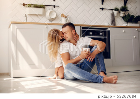 Beautiful couple spend time in a kitchen Beautiful couple spend time in a kitchen 55267684