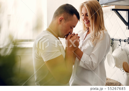 Beautiful couple spend time in a kitchen Beautiful couple spend time in a kitchen 55267685
