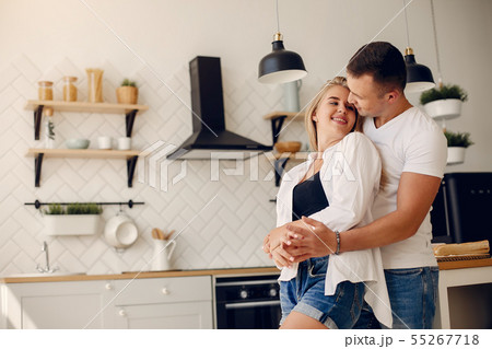 Beautiful couple spend time in a kitchen Beautiful couple spend time in a kitchen 55267718