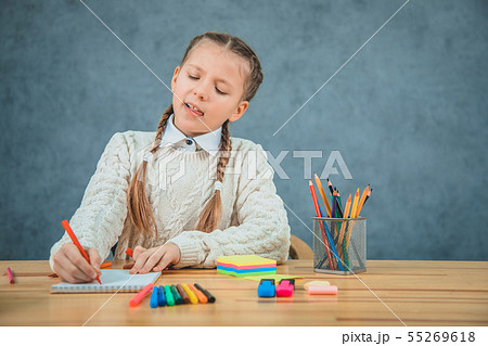 Little blond girl is getting bored of all studying stuff. 55269618