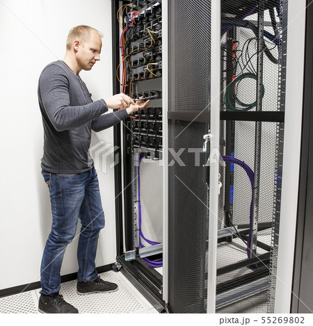 IT consultant building network rack in datacenter 55269802