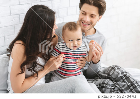 Cheerful parents playing with baby son at home 55270443