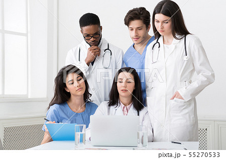 Multiracial doctors looking at laptop, working together in clinic 55270533