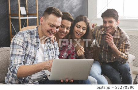 Laughing friends watching funny video on laptop 55270590