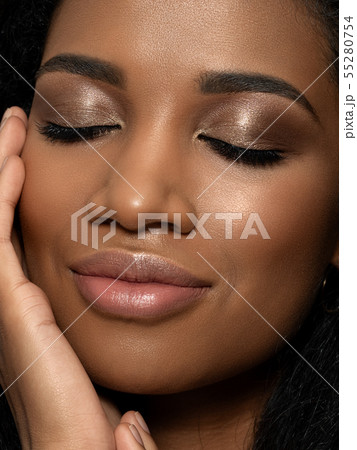 Young beautiful black woman touching her face Young beautiful black woman touching her face 55280754