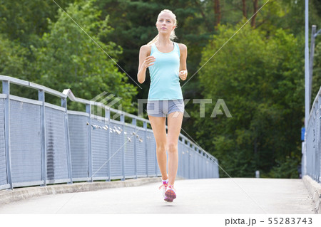 Young running woman trains her stamina outdoor Young running woman trains her stamina outdoor 55283743