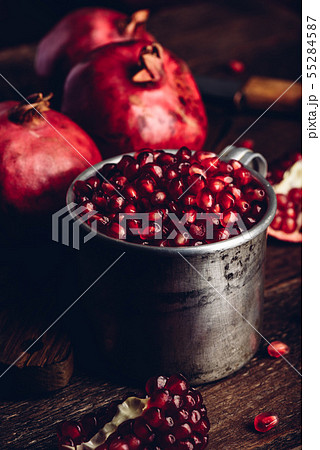 Rustic metal mug full of the pomegranate seeds Rustic metal mug full of the pomegranate seeds 55284587