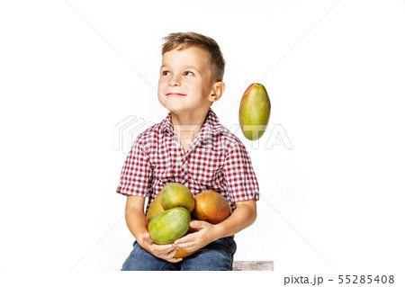 handsome boy in a red shirt with a mango 55285408