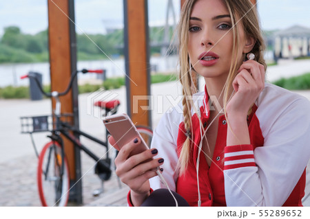 portrait outdoors of a young beautiful woman at 55289652