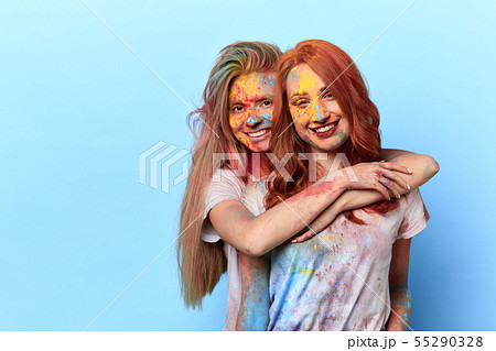 two positive girls embracing and posing to the camera 55290328
