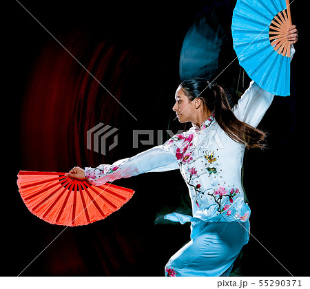 woman Tai Chi Chuan Tadjiquan posture isolated black background light painting 55290371