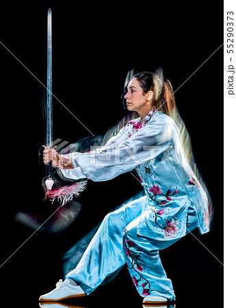 woman Tai Chi Chuan Tadjiquan posture isolated black background light painting 55290373