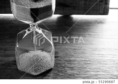 Mono tone sandhour on the table near the window. Mono tone sandhour on the table near the window. 55290687