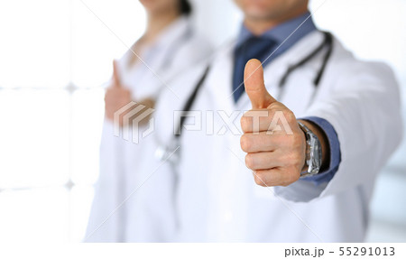 Group of doctors showing thumbs up. Perfect medical service in clinic. Happy future in medicine and 55291013
