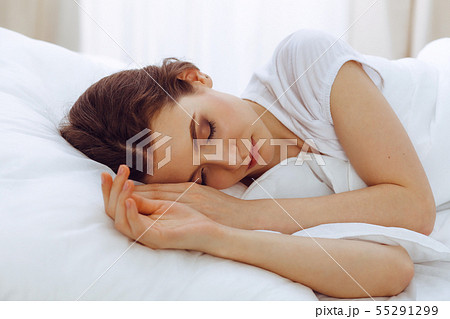 Beautiful young woman sleeping while lying in her bed. Concept of pleasant and rest reinstatement 55291299