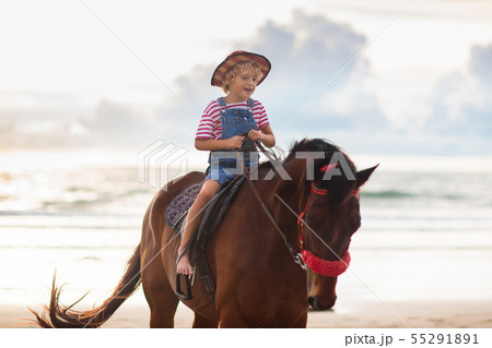 Kids riding horse on beach. Children ride horses. Kids riding horse on beach. Children ride horses. 55291891
