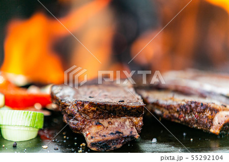 Fresh roasted meat on flaming grill. Fresh roasted meat on flaming grill. 55292104