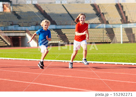 Child running in stadium. Kids run. Healthy sport. 55292271