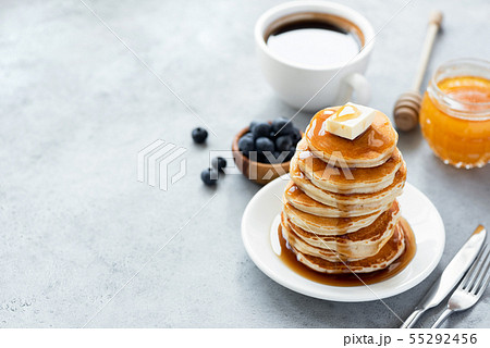 Pancakes with butter, syrup and cup of coffee Pancakes with butter, syrup and cup of coffee 55292456