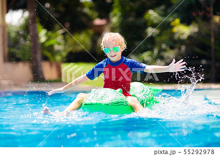 Child in swimming pool. Kid on inflatable float Child in swimming pool. Kid on inflatable float 55292978