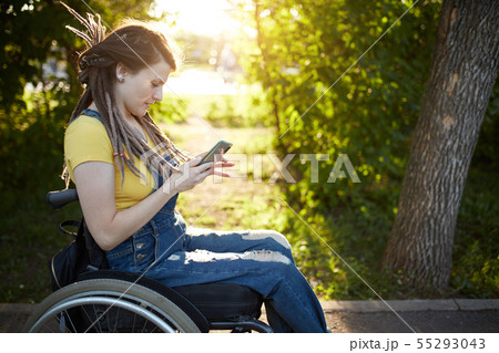 cheerful fashion girl spending time with her mobile phone cheerful fashion girl spending time with her mobile phone 55293043