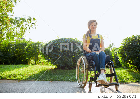 pleasant brown-haired girl spending spare time outdoors pleasant brown-haired girl spending spare time outdoors 55293071
