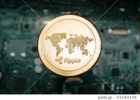 Gold Ripple coin, on background of computer Gold Ripple coin, on background of computer 55293370