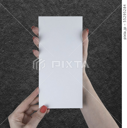 A woman holding white booklet A woman holding white booklet 55295284