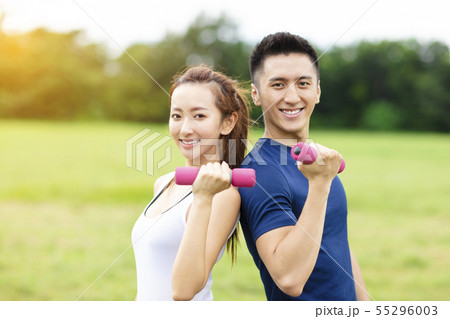 asian young couple training with dumbbells 55296003