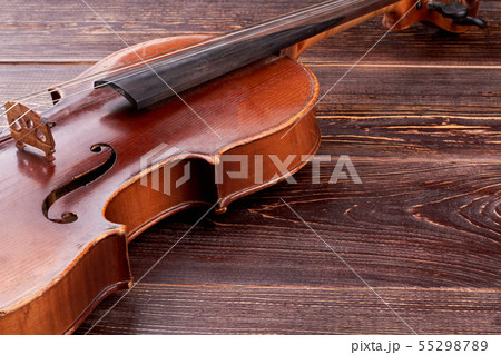 Old-fashioned violin on wooden background. Old-fashioned violin on wooden background. 55298789