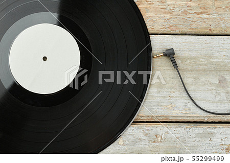 Vinyl LP record on wooden background. Vinyl LP record on wooden background. 55299499