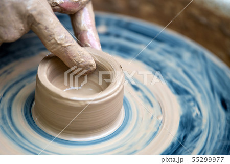 Potter makes pottery dishes on potter's wheel Potter makes pottery dishes on potter's wheel 55299977