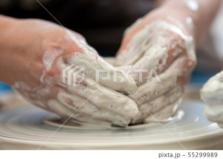 Potter makes pottery dishes on potter's wheel Potter makes pottery dishes on potter's wheel 55299989