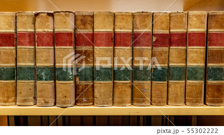 Antique books on wooden bookshelf in library Antique books on wooden bookshelf in library 55302222