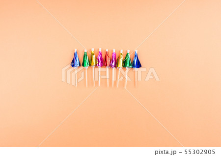 Rainbow neon cocktail umbrellas on orange 55302905