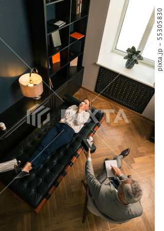 Upset blonde Caucasian woman lying on the couch Upset blonde Caucasian woman lying on the couch 55305830