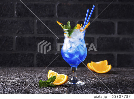 Blue cocktail drink with ice and orange 55307787