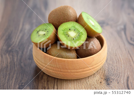 Kiwi fruit in a bowl on wooden background Kiwi fruit in a bowl on wooden background 55312740