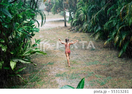 Pretty little girl enjoy the rain and dancing on the street in summer Pretty little girl enjoy the rain and dancing on the street in summer 55313281