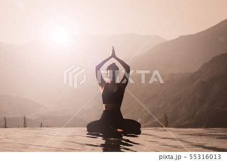 woman practice yoga on the pool 55316013