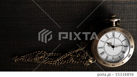 Antique pocket watch Placed on a black wooden Antique pocket watch Placed on a black wooden 55316856