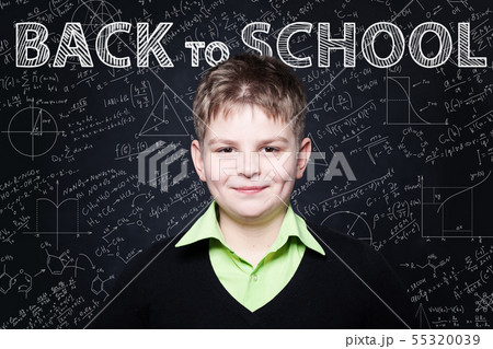 Young Student smiling on chalkboard. Young Student smiling on chalkboard. 55320039
