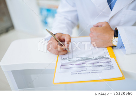 Close up of male hand that making notes Close up of male hand that making notes 55320960