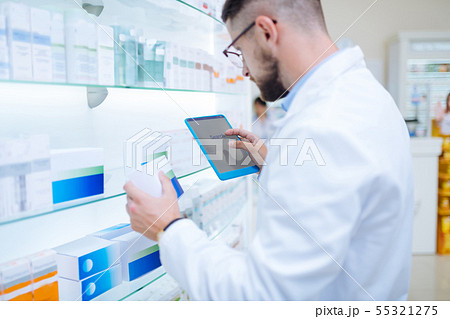 Serious brunette chemist searching information about pills Serious brunette chemist searching information about pills 55321275