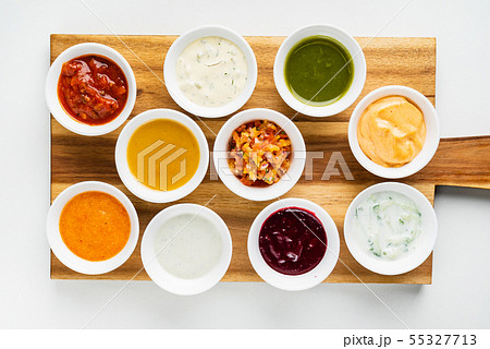 Bowls with sauces on wooden tray 55327713