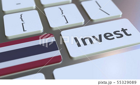 INVEST text and flag of Thailand on the buttons on the computer keyboard. Business related 55329089