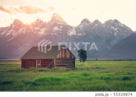 Old wooden house in mountains at summer sunset 55329874