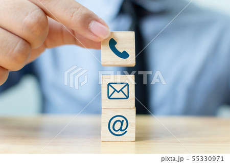 Businessman hand putting wooden block cube symbol 55330971